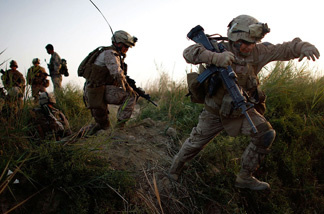 Lance Cpl. Chris Garcia and other members of Golf Company cross an irrigation ditch as the 2nd Battalion, 8th Marine Regiment moves into Helmand province in July during a major offensive against the Taliban stronghold in southern Afghanistan.
