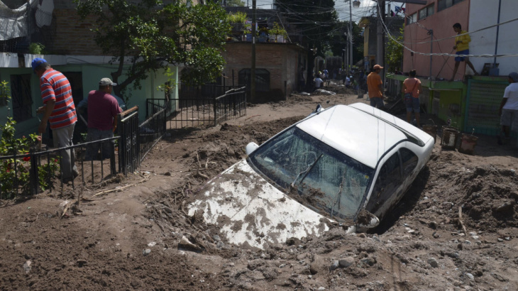 A car lays buried in mud after flooding triggered by Hurricane Manuel in Chilpancingo, Mexico.