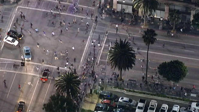 Police dispersed a crowd of several hundred who had gathered to see a film at the Vine Theater in Hollywood, after some began throwing items at passing cars and police on Saturday, October 13, 2012.