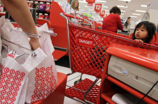 A young girl watches as a cashiers bags groceries at a Target store. U.S. consumer prices were flat last month, the latest sign inflation is in check. Low inflation leaves consumers with more money to spend, which benefits the economy. The consumer price index has risen 1.6 percent in the 12 months ending in January, the Labor Department said Thursday. That's down from a 2.9 percent pace a year ago.Excluding the volatile food and energy categories, core prices rose 0.3 percent in January, pushed up by higher costs for apparel, air fares and rents.
