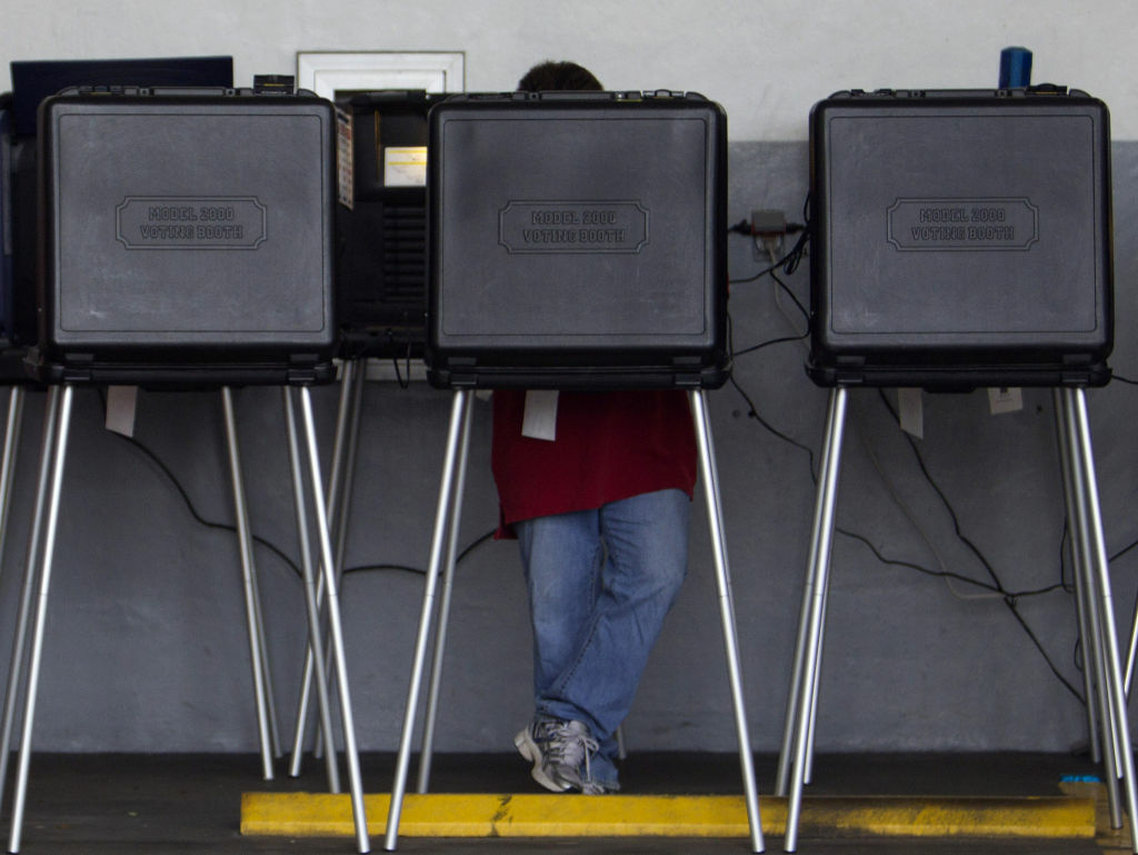 A voter casts his ballot in a West Miami, Fla., fire station during the Republican primary in January.