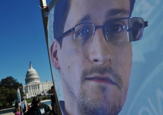 An image of Edward Snowden on the back of a banner is seen infront of the U.S. Capitol during a protest against government surveillance on October 26, 2013 in Washington, D.C.