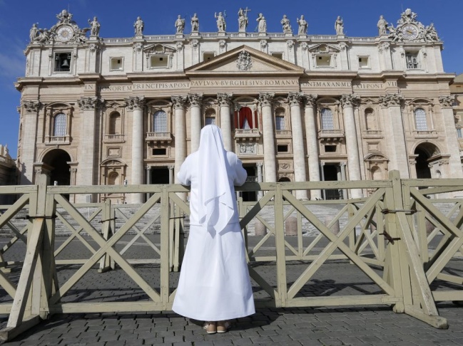 Outside Saint Peter's Basilica in Vatican City on Tuesday, a nun prayed. In the Sistine Chapel, cardinals were beginning their conclave to select the next pope.