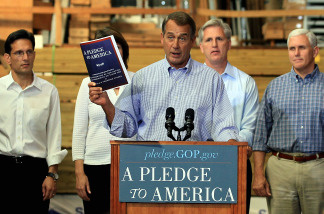 House Minority Leader John Boehner (R-OH), holds a copy of 'A Pledge To America', House Republicans' proposed governing agenda for the upcoming 111th Congress.