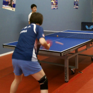Erica Wu practices table tennis with an opponent 