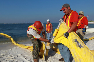 Workers assemble an oil containment boom in an attempt to protect the inlet waterways from the Deepwater Horizon oil spill in the Gulf of Mexico on June 7, 2010 in Pensacola, Florida.