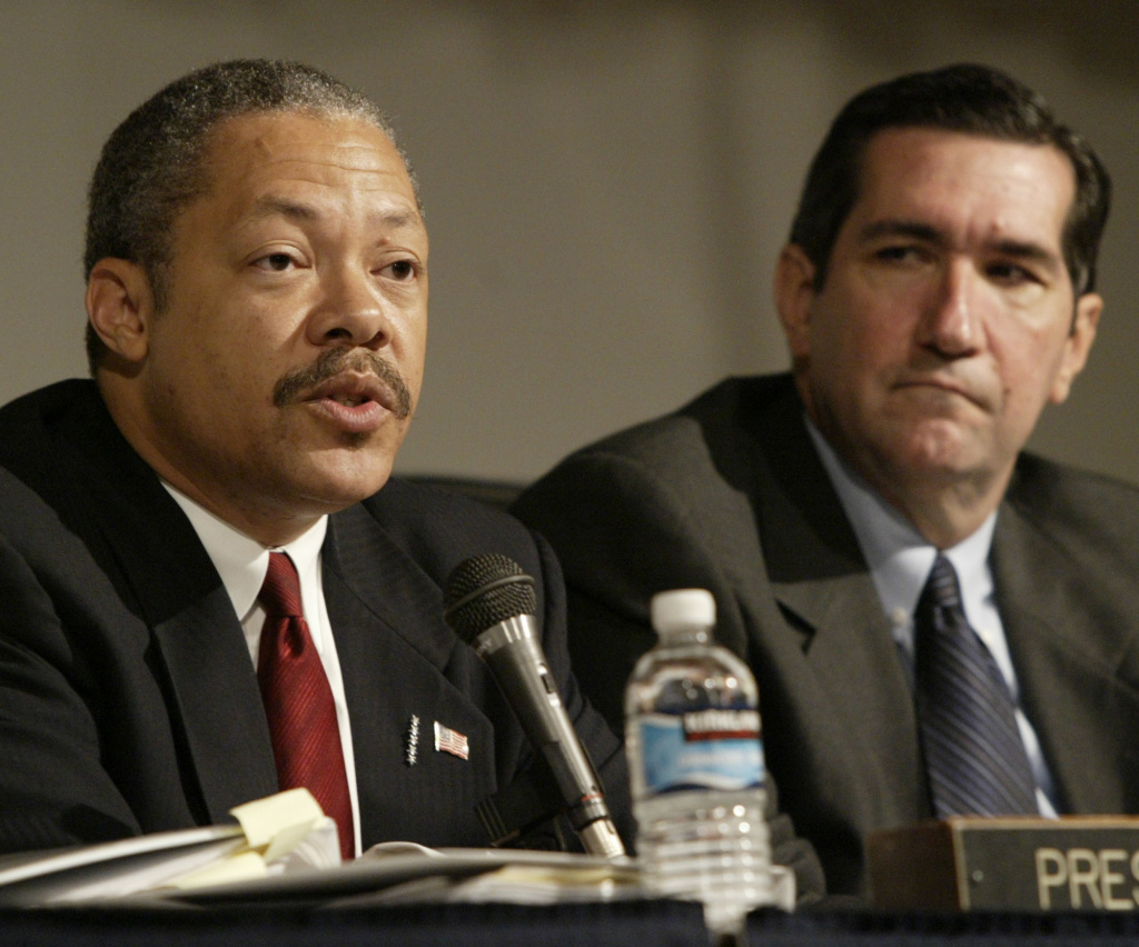In this file photo, David Cunningham, left, then-president of the Board of Police Commissioners, and Alan Skobin, vice president of the board, speak during a meeting of the Board of Police Commissioners Tuesday, July 13, 2004, in Los Angeles. Cunningham has filed a $10 million claim against UCLA police alleging that officers racially profiled him and used excessive force in a traffic stop that began over not wearing his seat belt.
