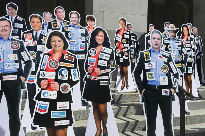 A proposed general election ballot initiative would require state lawmakers to wear their top donors' labels on their clothes in the fashion of NASCAR drivers.