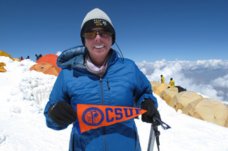 Cindy L. Abbott, a proud Titan, sports a Cal State Fullerton banner at Peak Lenin in Kyrgyzstan.