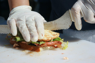 A worker prepares a sandwich at Monsieur Egg.