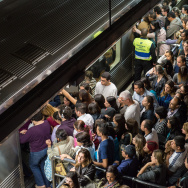 Commuters board a train during the eveni