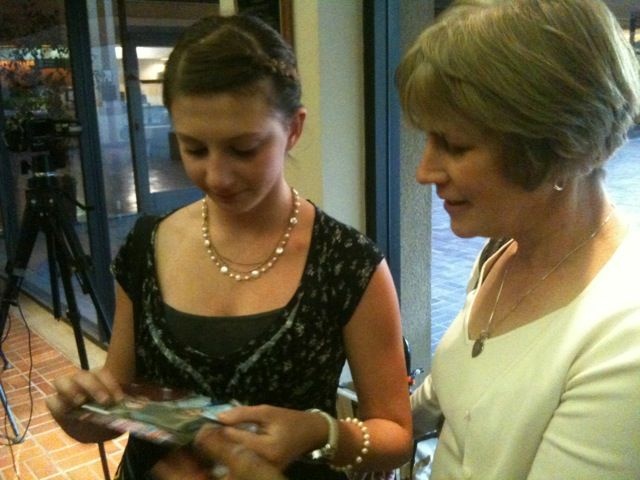Mackensie and Claudia Souser of Camarillo look at photos of Doyle Souser, who died in the Metrolink train crash in Chatsworth in September 2008.