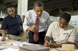 U.S. President Barack Obama (C) speaks with employee Elaine Hart (R) as he tours Gelberg Signs with company Principal Luc Brami during a visit to highlight the administration's initiatives to create jobs August 6, 2010 in Washington, DC.