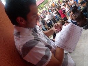 A young man looks over a petition during a deferred action informational event in Texas, June 20, 2010
