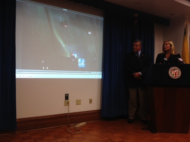 L.A. City Attorney Carmen Trutanich and deputy city attorney Denise Mills show TV news helicopter video from the April 11 police shooting of Abdul Arian at news conference announcing that the lawsuit was dismissed.