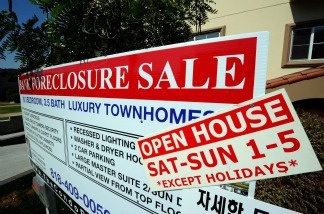 A bank foreclosure sale sign is posted in front of townhouses on Aug. 12, 2010 in Los Angeles.