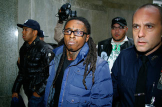 Lil Wayne (C) arrives in court for weapon charges at the New York State Supreme Court on Dec. 15, 2009 in New York City.