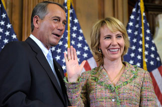 In this Jan. 5, 2011 file photo, House Speaker John Boehner reenacts the swearing in of Rep. Gabrielle Giffords, D-Ariz., on Capitol Hill in Washington.