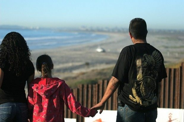 A family looks north into the United States from Playas de Tijuana, January 2009