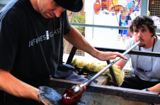 Christopher Jeffries, left, shapes a glass mug as his assistant Cameron Dougherty blows through the pipe to give the piece its final form at the Sawdust Art Festival on July 25, 2010 in Laguna Beach, Calif.