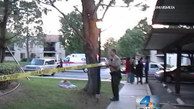 Sheriff's deputies cordon off the area around a Palmdale apartment complex where a boy was nearly drowned in the swimming pool on Thursday, May 24, 2012.