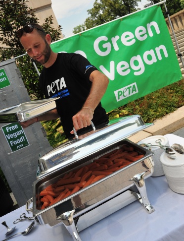 A PETA volunteer places the lid on a ser