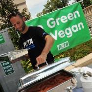 A PETA volunteer places the lid on a ser