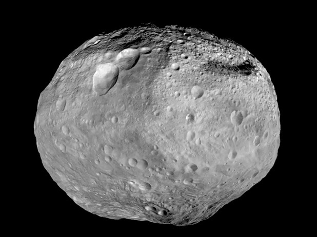 This mosaic image from NASA's Dawn spacecraft, captured between 2011 to 2012, shows the giant asteroid Vesta. The mountain at the south pole, seen at the bottom of the image, is more than twice the height of Mount Everest.