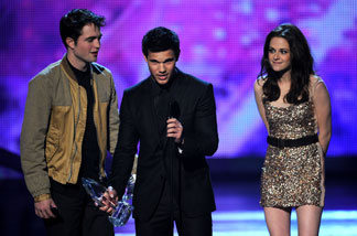 (L-R) Actor Robert Pattinson, actress Kristen Stewart, and actor Taylor Lautner accept the Favorite Movie Award for 'The Twilight Saga: Eclipse' onstage during the 2011 People's Choice Awards at Nokia Theatre L.A. Live on January 5, 2011 in Los Angeles, California.