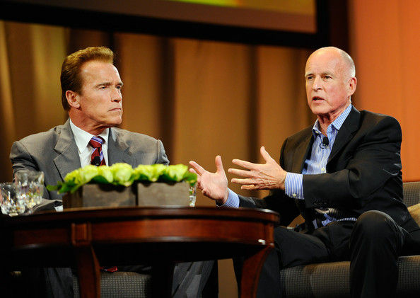 Then-Democratic candidate for governor Jerry Brown (R) speaks as then-California Gov. Arnold Schwarzenegger (L) looks on during a discussion moderated by 'Today' show host Matt Lauer during the Women's Conference 2010 on October 26, 2010 at the Long Beach Convention Center in Long Beach, California.