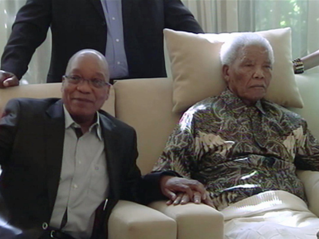 In an image taken from video, South African President Jacob Zuma, left, sits with the ailing anti-apartheid icon Nelson Madela in April.
