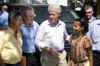 In this handout image provided by the United Nations Stabilization Mission in Haiti (MINUSTAH), Former U.S. Presidents, William Jefferson Clinton (2R) and George W. Bush (2L), speak to the owners of the Caribbean Crafts factory on March 22, 2010 in Port-au-Prince, Haiti. Former U.S. Presidents George W. Bush and Bill Clinton have been visiting Haiti as part of their fund-raising efforts to aid the earthquake-stricken nation. At least 220,000 people were killed and large parts of the capital, Port-au-Prince and other towns were leveled in the magnitude 7.0 quake.