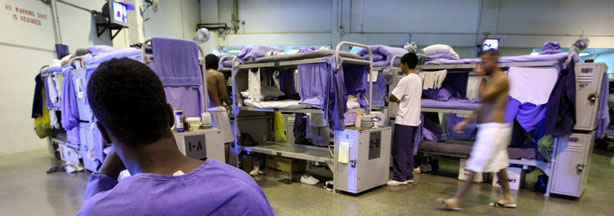 File photo: Inmates at the Mule Creek State Prison walk near their bunk beds in a gymnasium that was modified to house prisoners August 28, 2007 in Ione, California.