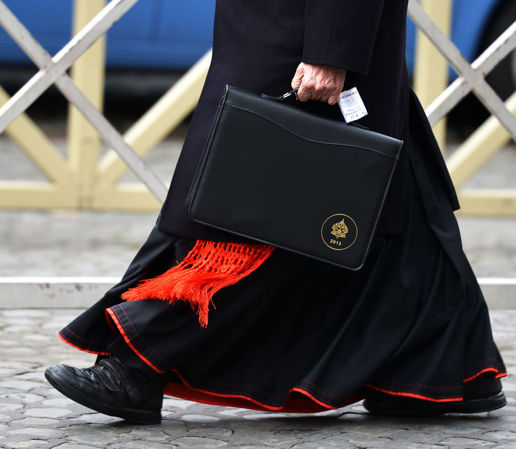 Roman Catholic cardinals have been meeting at the Vatican to get to know each other better and to set a date for the start of the conclave that will choose the next pope. On Thursday, this cardinal was walking to one of those meetings.