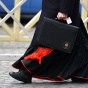 Roman Catholic cardinals have been meeting at the Vatican to get to know each other better and to set a date for the start of the conclave that will choose the next pope. On Thursday, this cardinal was walking to one of those meetings.
