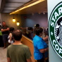 Customers queue for coffee at Starbucks
