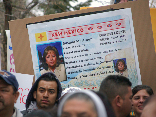 Immigrant advocates use an image of New Mexico Gov. Susana Martinez on a mock state driver's license during a 2012 rally in Santa Fe to protest her proposal to repeal a state law that allows illegal immigrants to obtain driver's licenses.