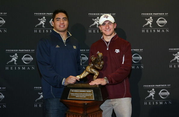 Manti Te'o and Johnny Manziel pose in front of the Heisman Award Trophy in New York City on December 7, 2012.