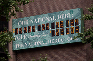 The National Debt Clock, a billboard-size digital display showing the increasing US debt, is seen on the corner of Sixth Avenue and West 44th Street on August 1, 2011 in New York City.