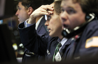 File photo: Traders work on the floor of the New York Stock Exchange before the closing bell February 22, 2011 in New York City.