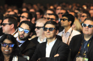 Moviegoers wear 3-D glasses to watch a 3-D film.