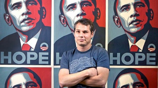 Shepard Fairey poses in front of the Barack Obama Hope artwork he designed in the Echo Park area of Los Angeles, in this Jan. 12, 2009 file photo.