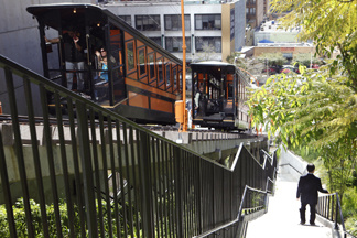 A man walks down hill as the Angels Flight Railway, the so-called "Shortest Railway in the World" resumes ferrying passengers up and down Bunker Hill in downtown Los Angeles Monday March, 15, 2010. The funicular that shut down nine years ago after a deadly accident, resumed service this year.