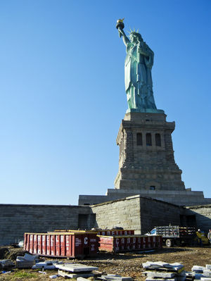 The Statue of Liberty survived Sandy unscathed, but Liberty Island remains closed indefinitely as workers remove mud and debris.