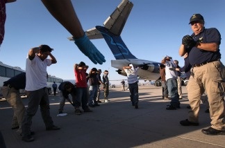 Guatemalan immigrants are body searched before boarding a deportation flight to Guatemala City, Guatemala on June 24, 2011 in Mesa, Arizona. Department of Homeland Security Secretary Jeh Johnson is reportedly considering limiting the deportations of people without serious criminal records, as the agency reviews its deportation practices.