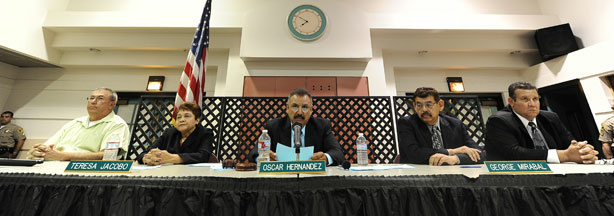 File photo: (L-R) City of Bell council members Lorenzo Velez, vice mayor Teresa Jacobo, mayor Oscar Hernandez, Councilman George Mirabel and Councilman Luis Artiga listen to residents asking them to resign during a council meeting on July 26, 2010 in Bell, California.