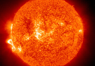 In this handout photo provided by NASA, a Solar and Heliospheric Observatory image shows Region 486 that unleashed a record flare last week (lower left) November 18, 2003 on the sun. The spot itself cannot yet be seen but large, hot, gas-filled loops above this region are visible. These post-flare loops are still active.