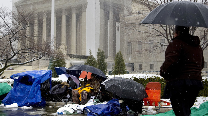 People wait through winter weather Monday outside the U.S. Supreme Court, in line hoping to attend oral arguments in the same-sex marriage cases being argued Tuesday and Wednesday.