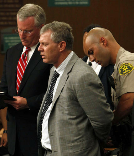 Lenny Dykstra being cuffed in March after he pled no contest to grand theft auto.