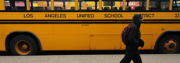 A student on his way to school walks past a Los Angeles Unified School District (LAUSD) school, in Los Angeles, California on February 13, 2009.